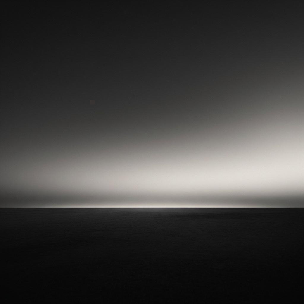 A horizon line where the deep indigo of night meets the first gold band of dawn -- the precise moment of transition, neither fully dark nor fully light